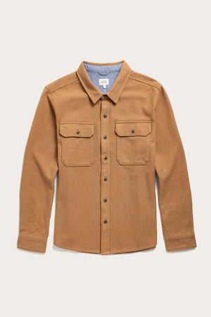 The Bridge & Burn Pointer Overshirt in camel is a tan twill style with long sleeves, two chest pockets, brown buttons, and a light blue fabric lining inside the collar—an eco-friendly and stylish choice. Displayed flat on a light background.