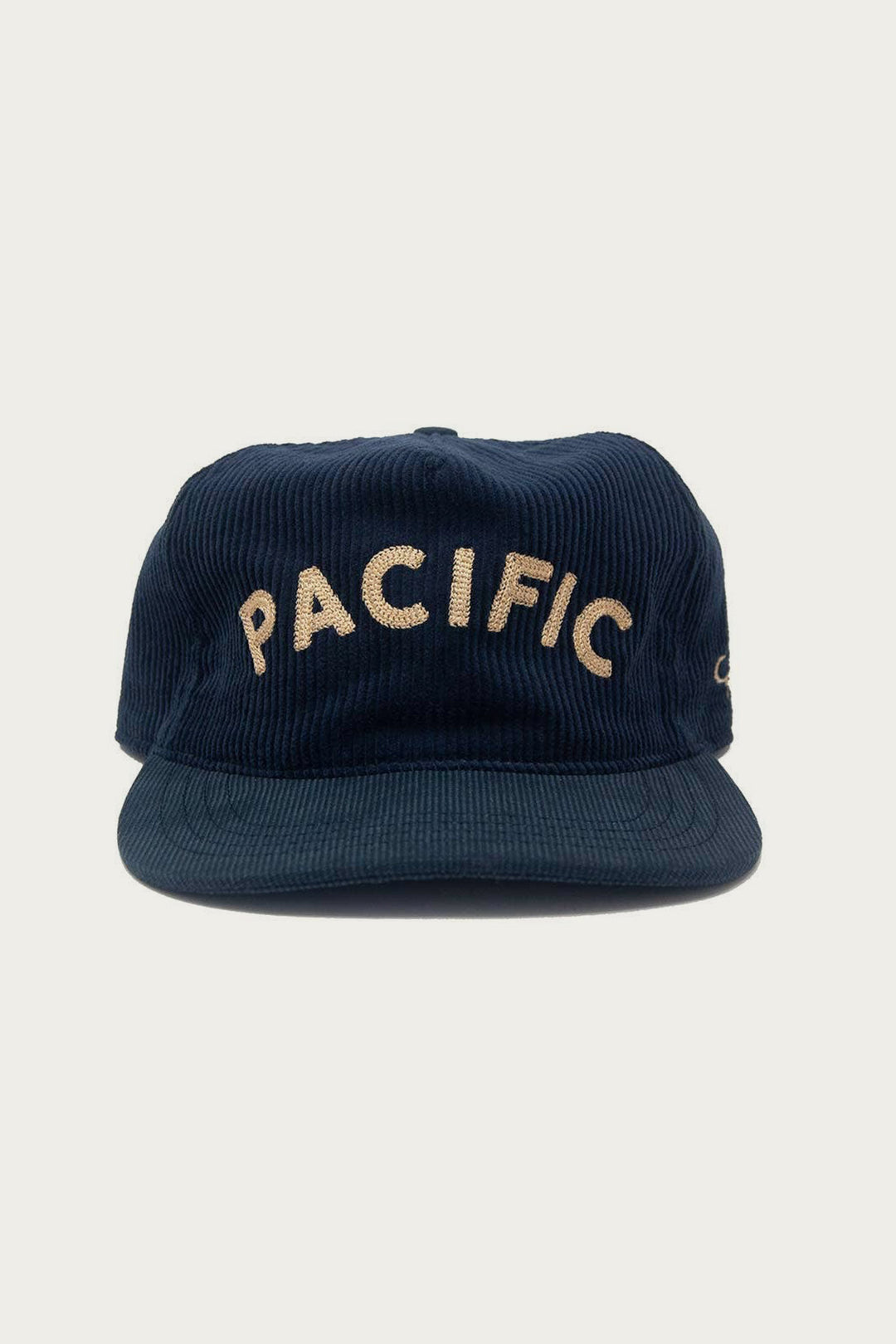 The Ampal Creative - Pacific III Strapback in navy features vintage-style beige "PACIFIC" embroidery on the front, captured against a plain light background.