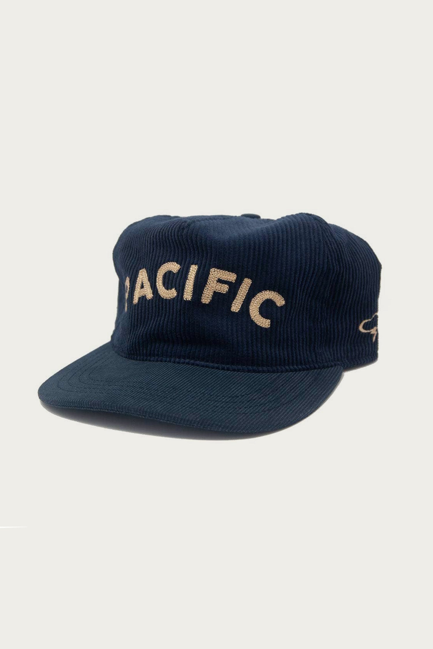 The Ampal Creative - Pacific III Strapback / Navy features vintage tan PACIFIC embroidery on the front and a white wave graphic on the side, bringing timeless flair to any outfit.