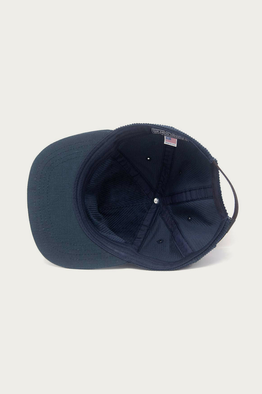 The Ampal Creative - Pacific III Strapback / Navy hat is shown from above, revealing its inner structure, stitching, and brim against a plain white background.