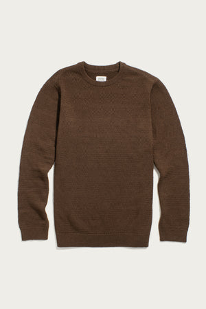 The Bridge & Burn Calder Sweater in Walnut is a brown, sustainable knit with a textured pattern, long sleeves, and ribbed cuffs, collar, and hem, shown laid flat on a white background.
