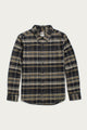 The Bridge & Burn Larson Shirt in Volcanic Plaid is a long-sleeve, button-up flannel with black, gray, and beige tones, a single chest pocket, and pointed collar. Made from recycled cotton. Laid flat on a white background.