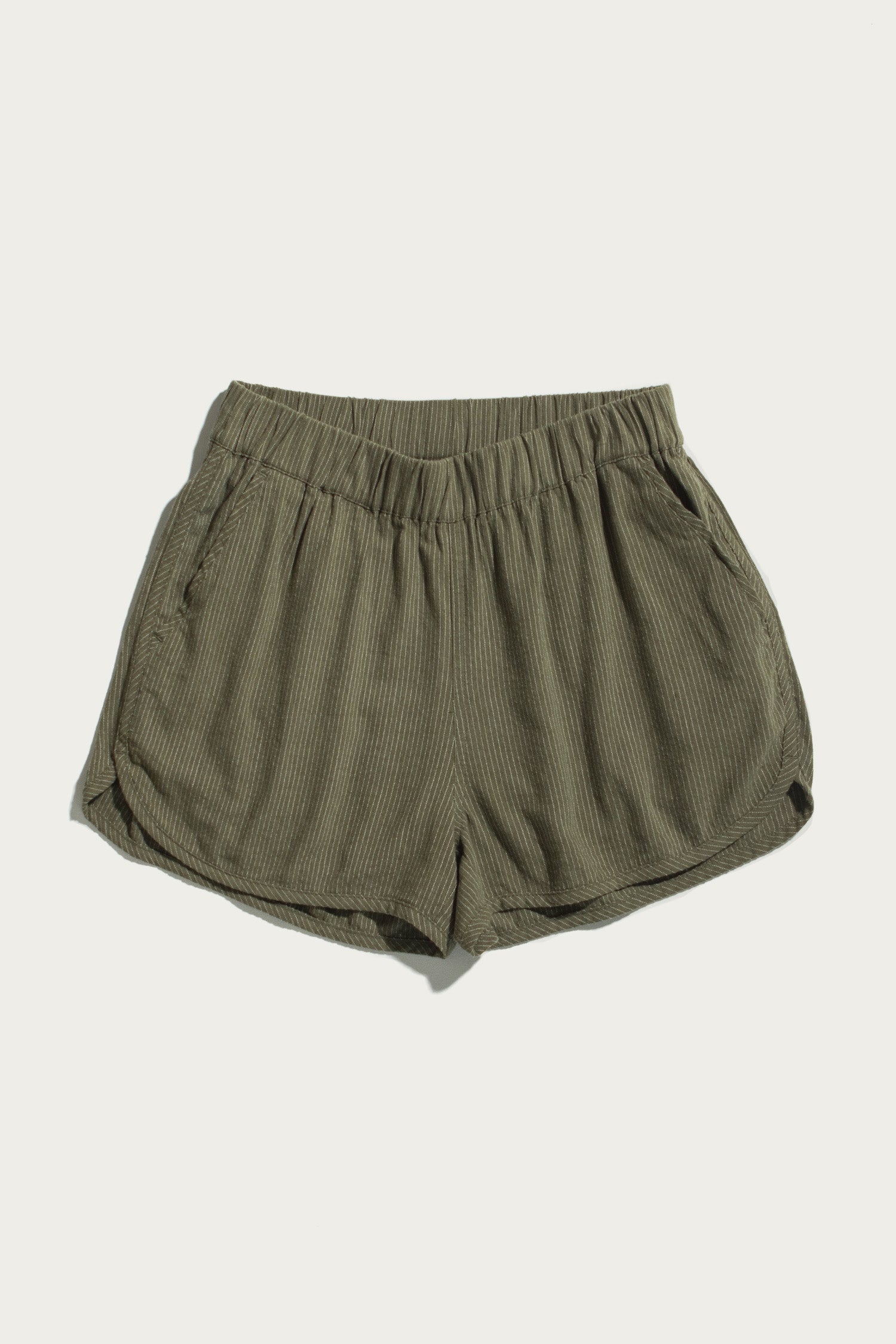 The Bridge & Burn Luca Track Short in Olive Pinstripe features a ribbed fabric, elastic waistband, and side pockets, shown laid flat on a plain white background.