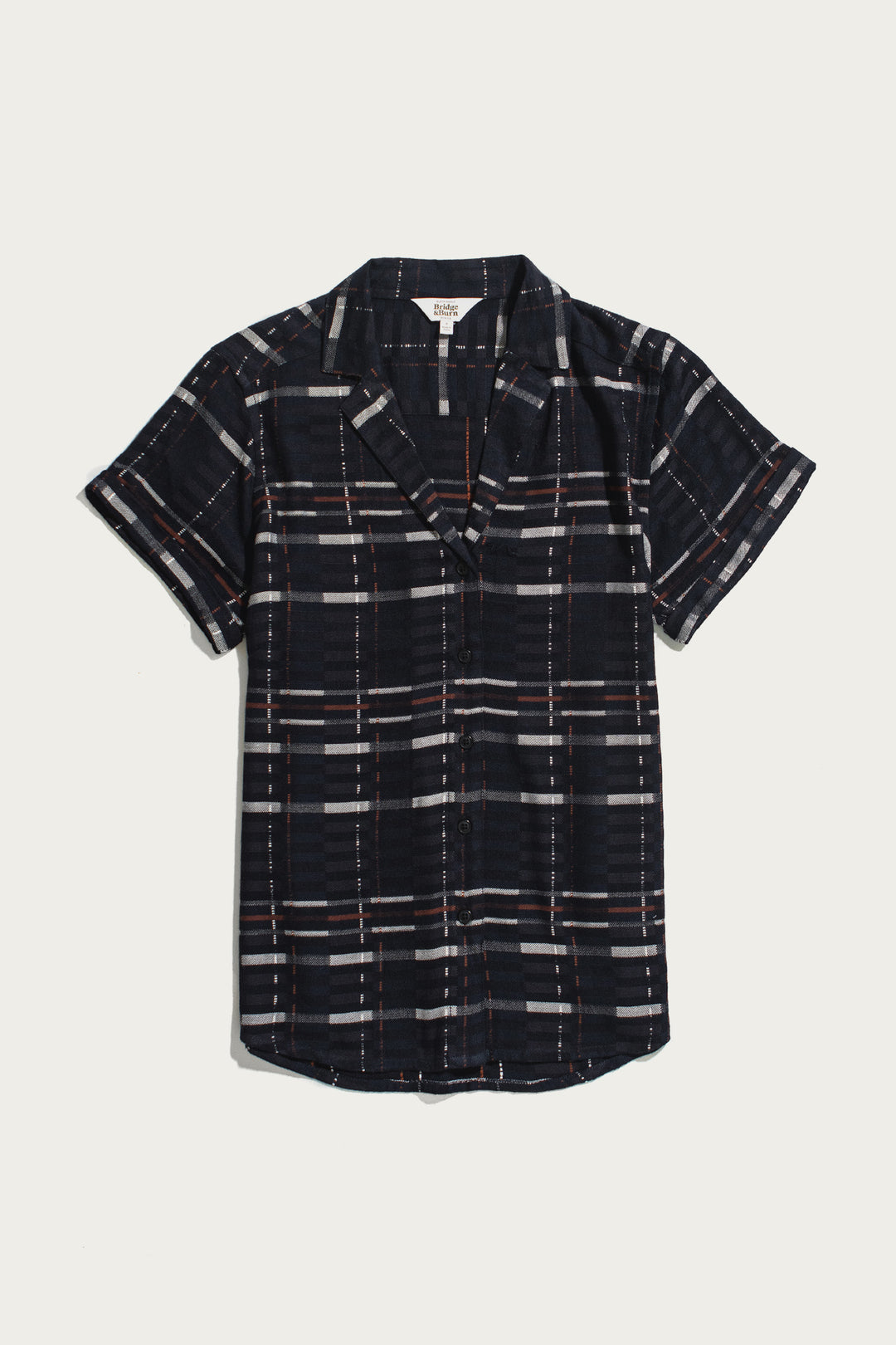 The Bridge & Burn Innes Shirt / Nightfall Stripe is a short-sleeve, relaxed fit button-up featuring a dark navy base with white and red stripes, crafted from eco-friendly viscose and displayed laid flat on a white background.