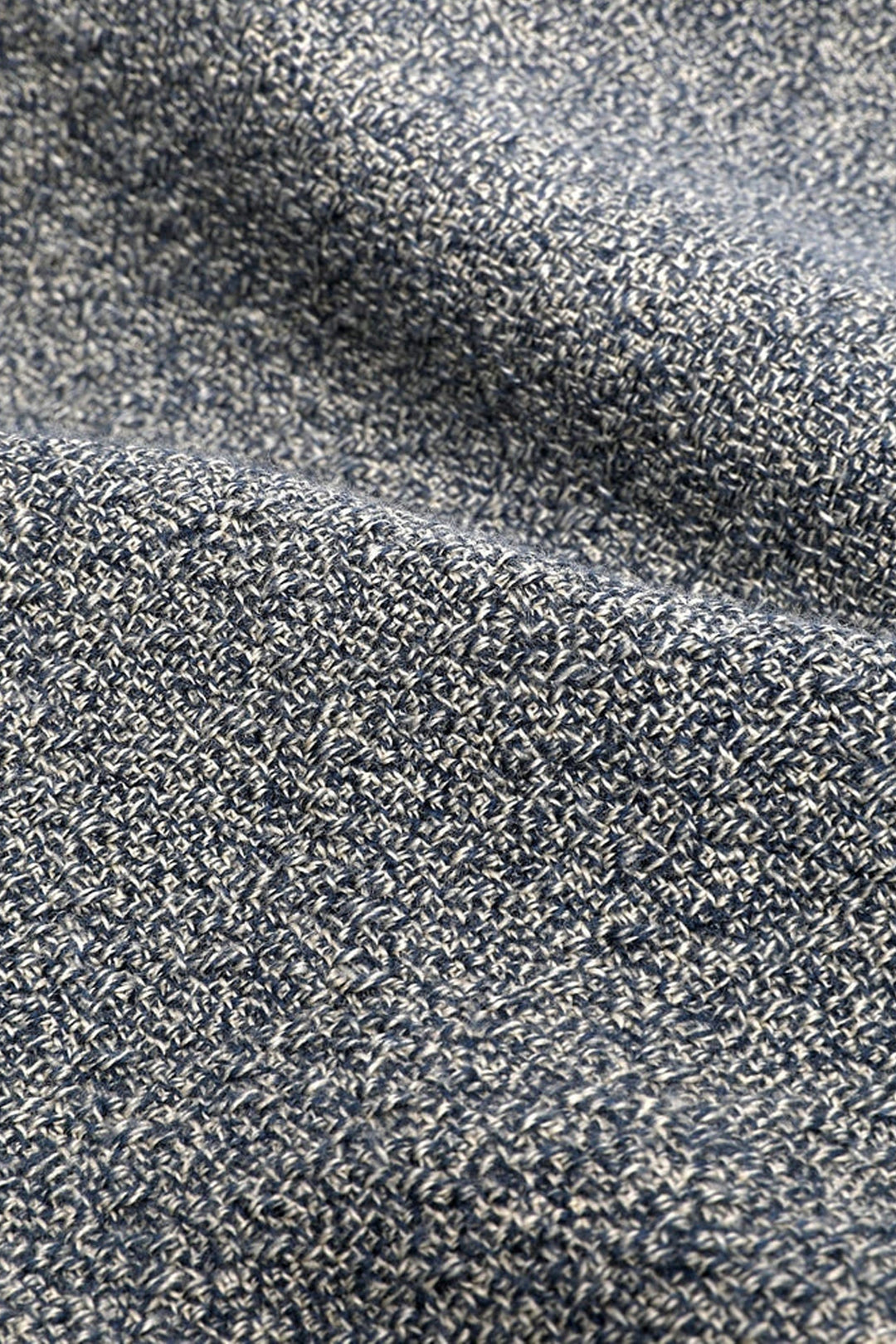 Close-up of the Corridor Pearl Boucle Shirt in Navy by Corridor, highlighting its textured, lightweight knit fabric in blue and white with a detailed pattern and gentle folds for a soft, unique surface.