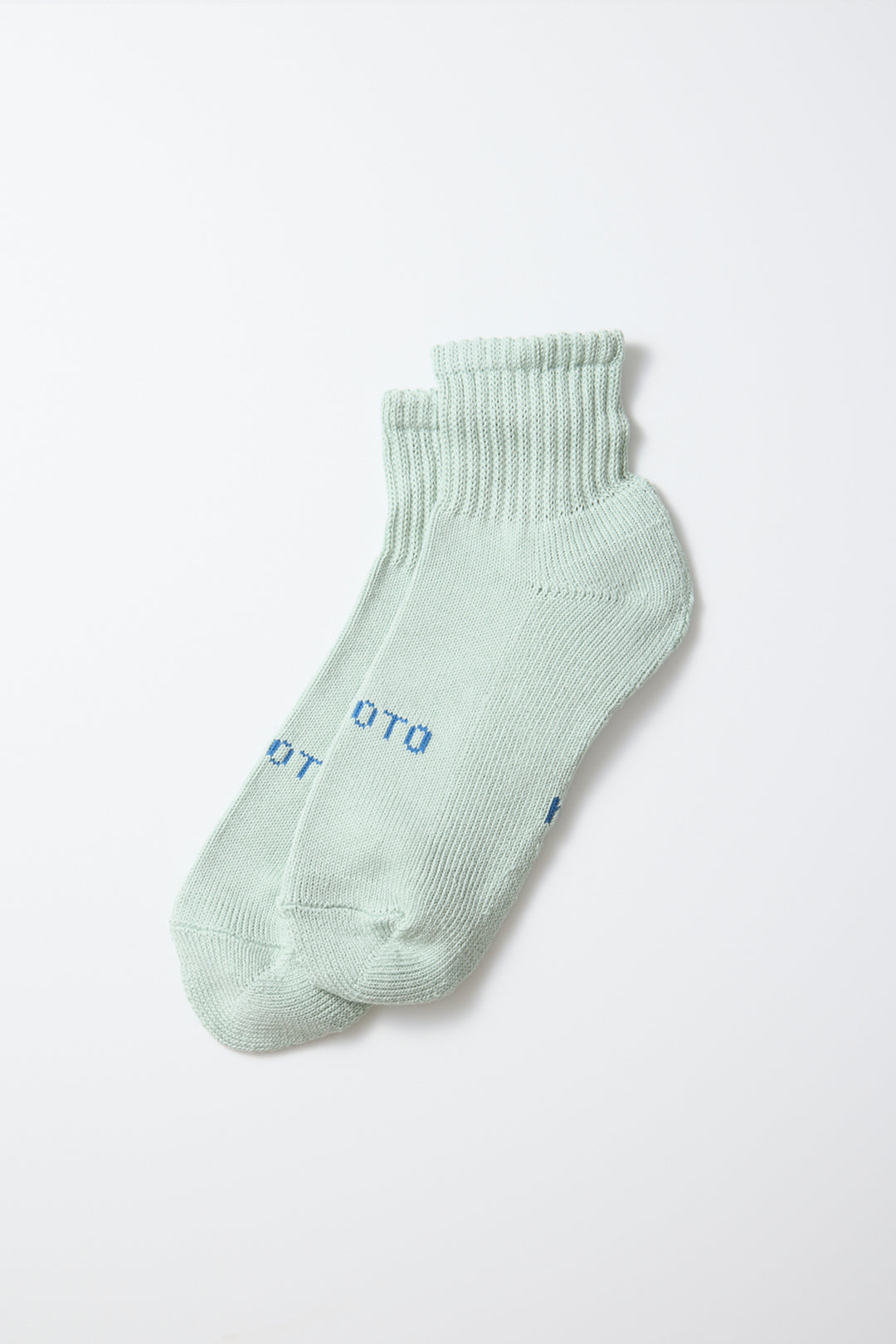 A pair of RoToTo Everyday Pile Ankle Socks in Aqua by RoToTo, crafted in Japan with ribbed cuffs and small blue text on the top, displayed against a plain white background.