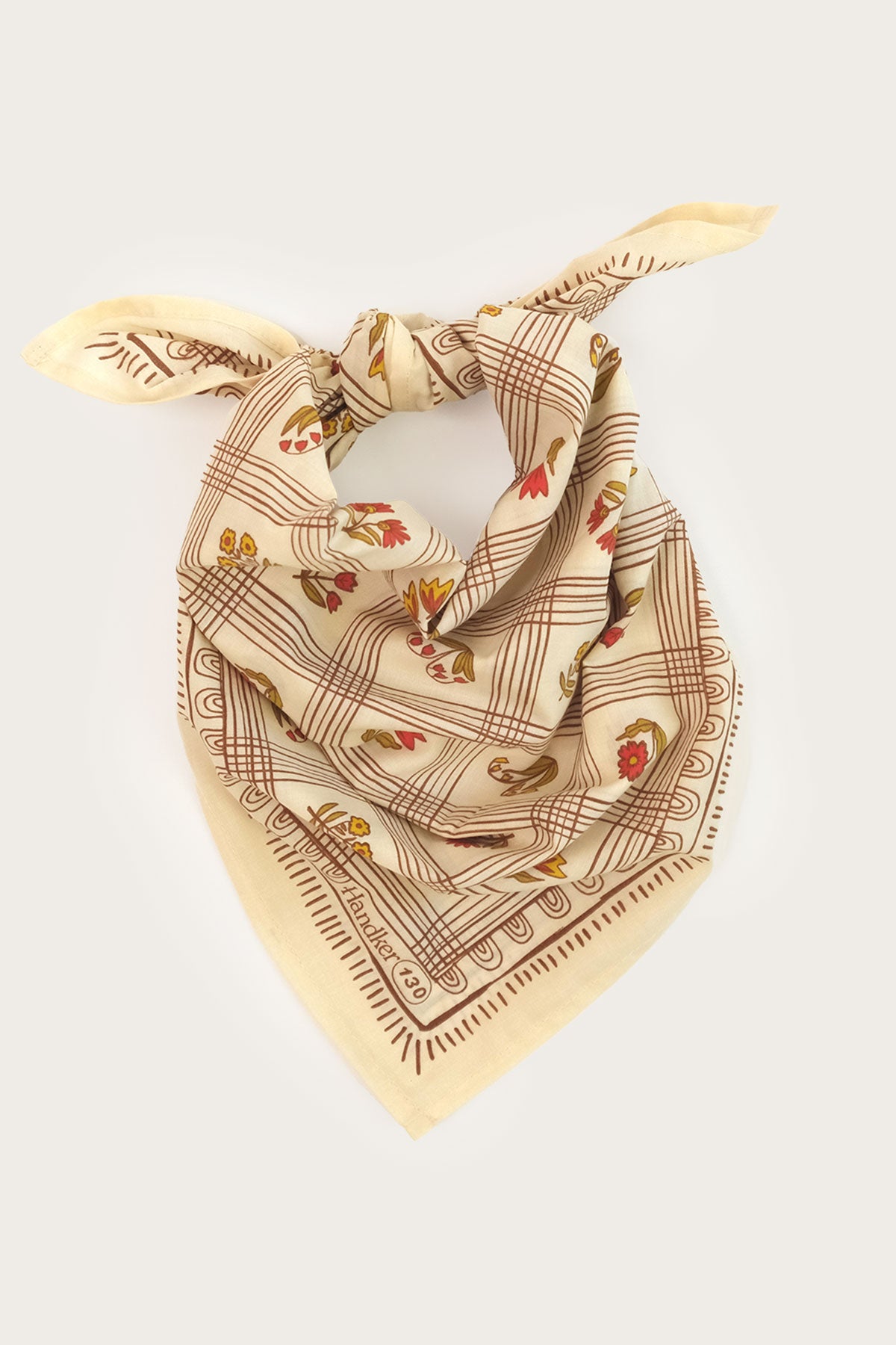 The Handker Bandanas - No. 130 Laura Bandana by Handker Bandanas is a premium light beige cotton bandana with brown plaid, floral patterns, red and yellow flowers, and decorative borders—hand screen-printed for versatile style.