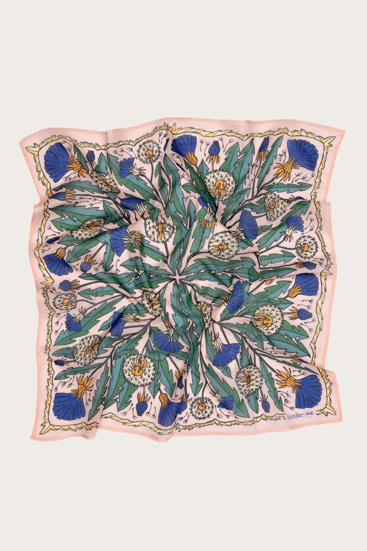The Handker Bandanas - 34" Dandy Wild Rag Bandana by Handker Bandanas is a large silk square with green leaves, white and orange flowers, blue thistles, and a pale pink and gold border, shown laid flat with slight wrinkles.