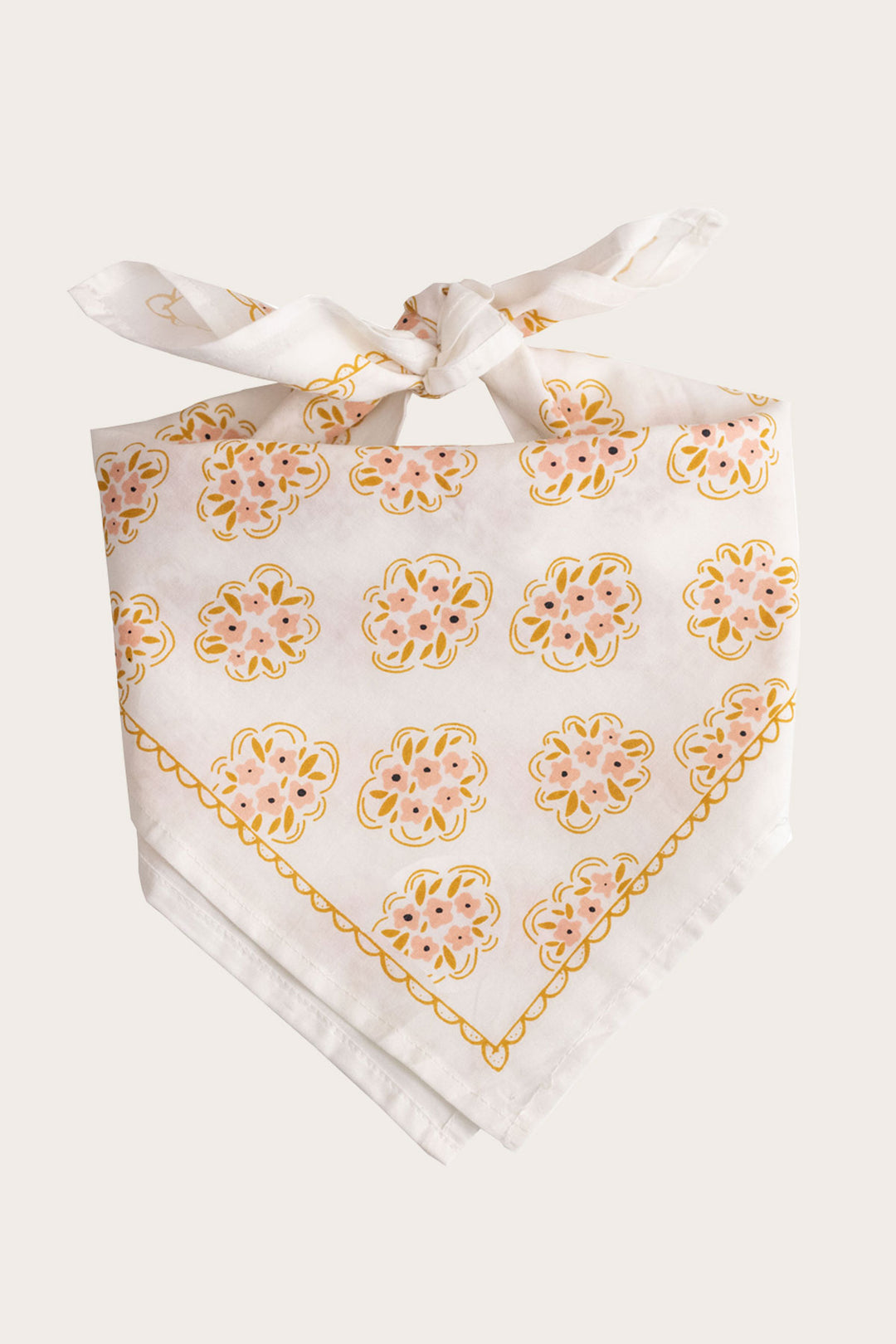 The Handker Bandanas - No. 042 Pearl Bandana by Handker Bandanas features a white cotton base, pink and yellow floral pattern, and a decorative yellow border, folded and tied at the top.