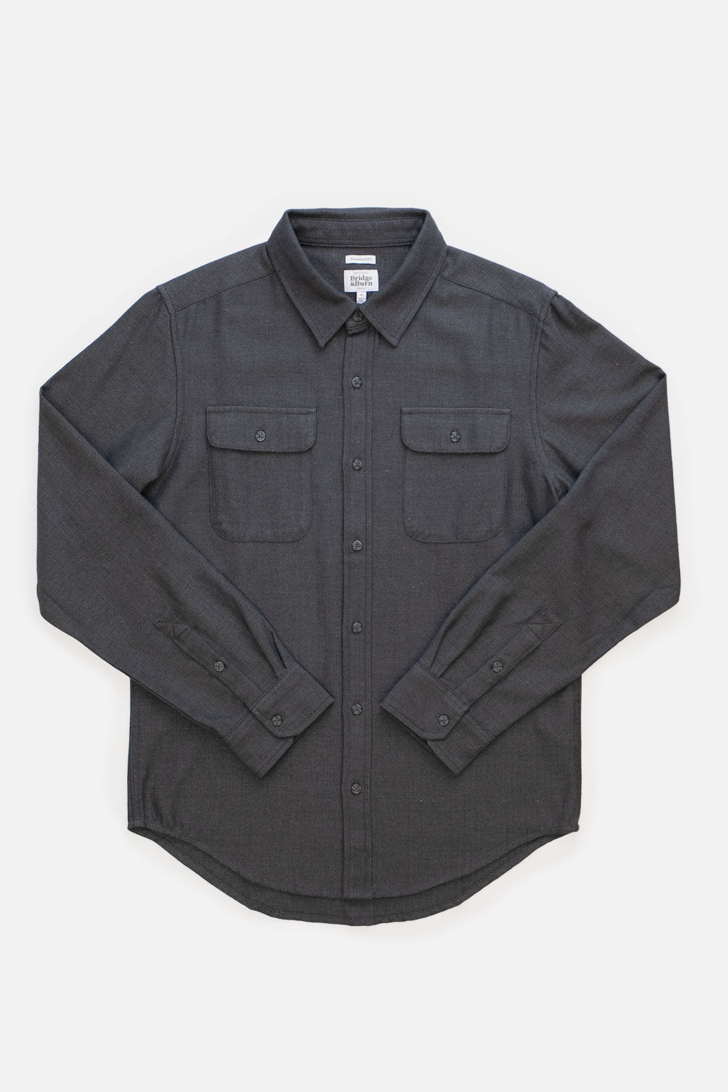 Bridge & Burn’s Bedford Shirt in Charcoal Herringbone is a men’s long-sleeve overshirt with two chest pockets and a collar, shown laid flat on a white background.