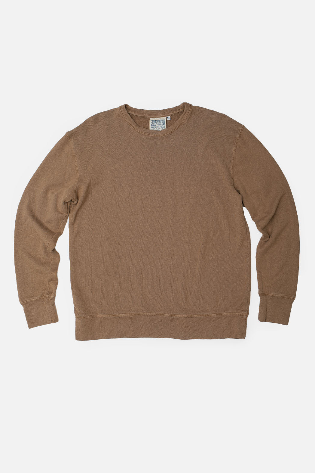 The Jungmaven Tahoe Sweatshirt in Coyote, crafted from organic cotton, features a ribbed crewneck, cuffs, and waistband. Laid flat on a white background, the inside back neck tag is visible.