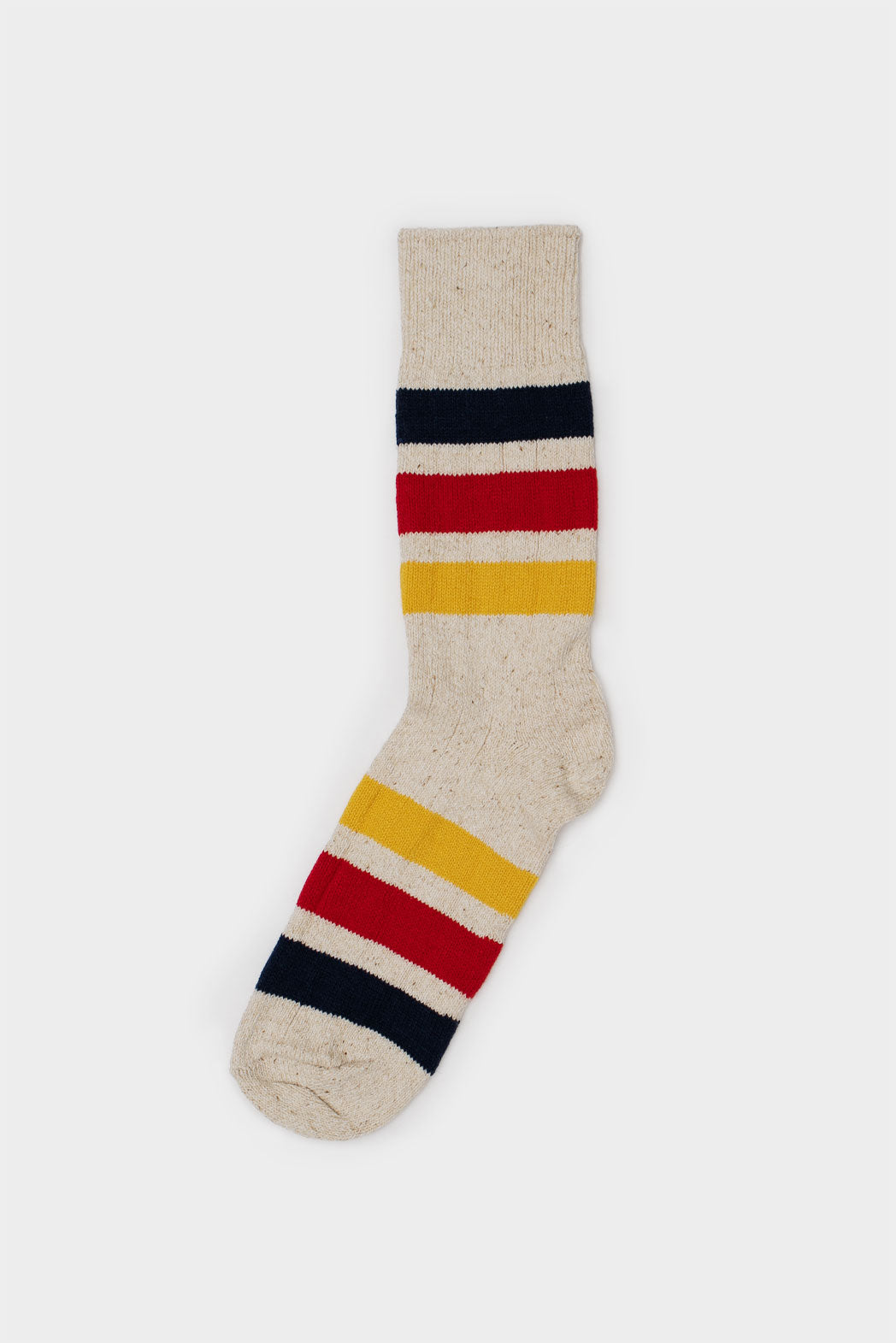 A single RoToTo Park Stripe Crew Sock in ivory with chunky navy, red, and yellow stripes on the ankle and foot is displayed against a plain white background.
