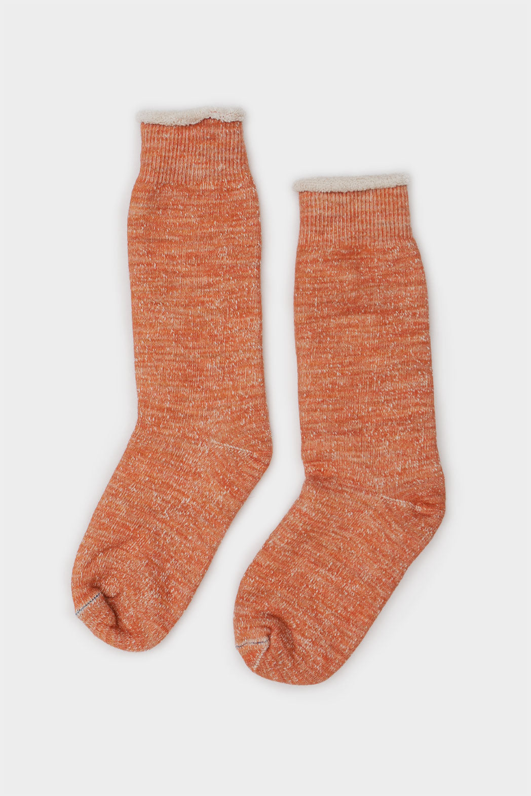 A pair of RoToTo Double Face Crew Socks in orange, made in Japan, with a heathered texture and ribbed cuff by RoToTo, displayed side by side on a plain light background.