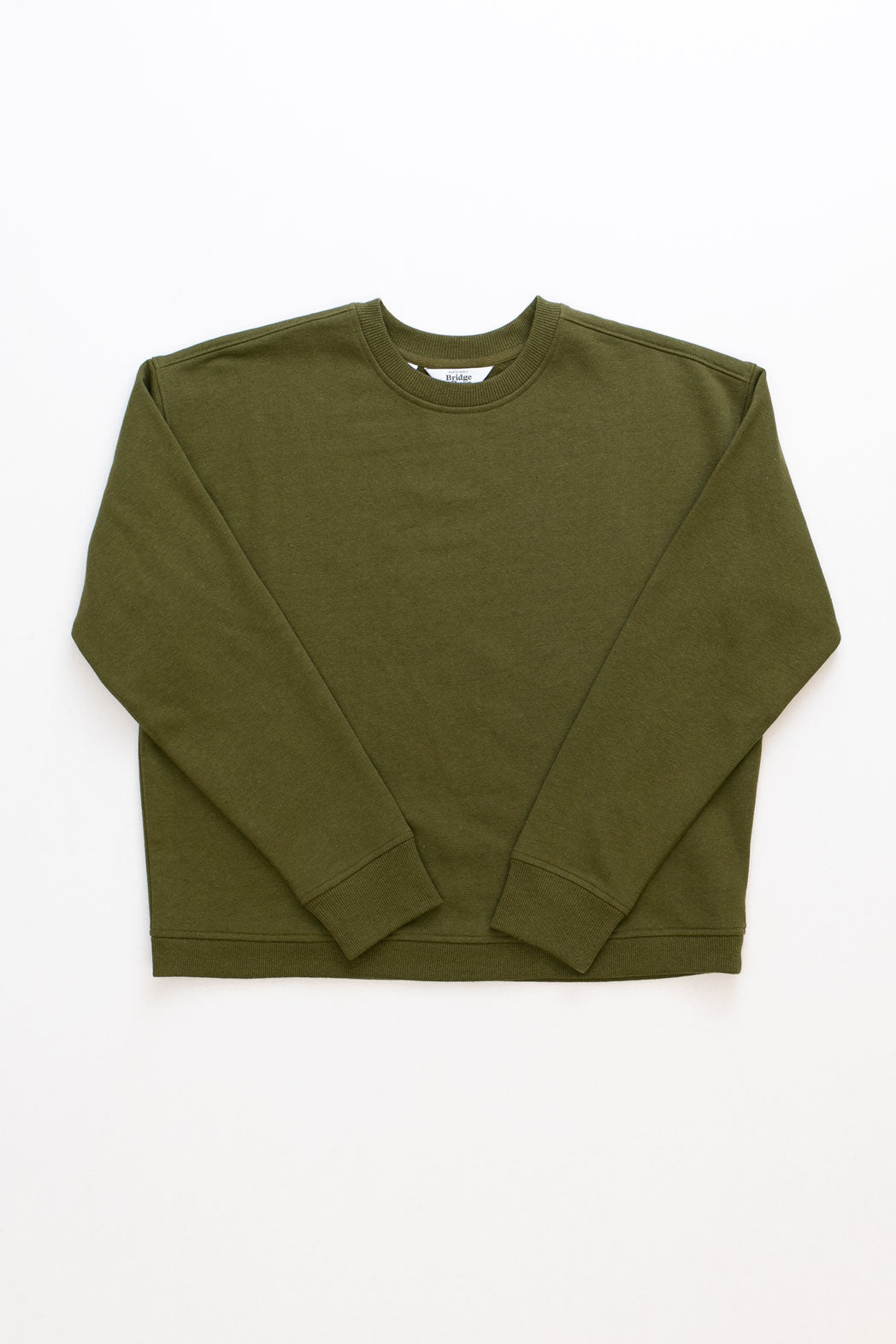 The Hawthorne Boxy Crew Sweatshirt in olive by Bridge & Burn is laid flat on a white background.