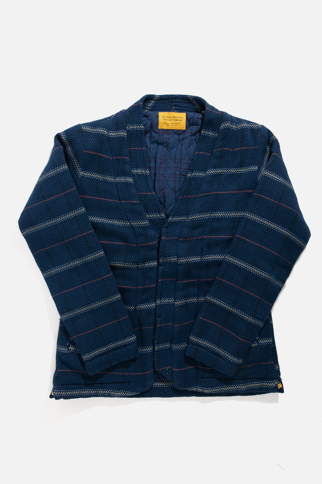 The Original Madras Trading Company Original Madras Lined Cardigan / Chevron Weave is a blue, striped, quilted V-neck jacket with long sleeves, quilted lining, and a yellow tag on the inside collar, shown laid flat on a white background.